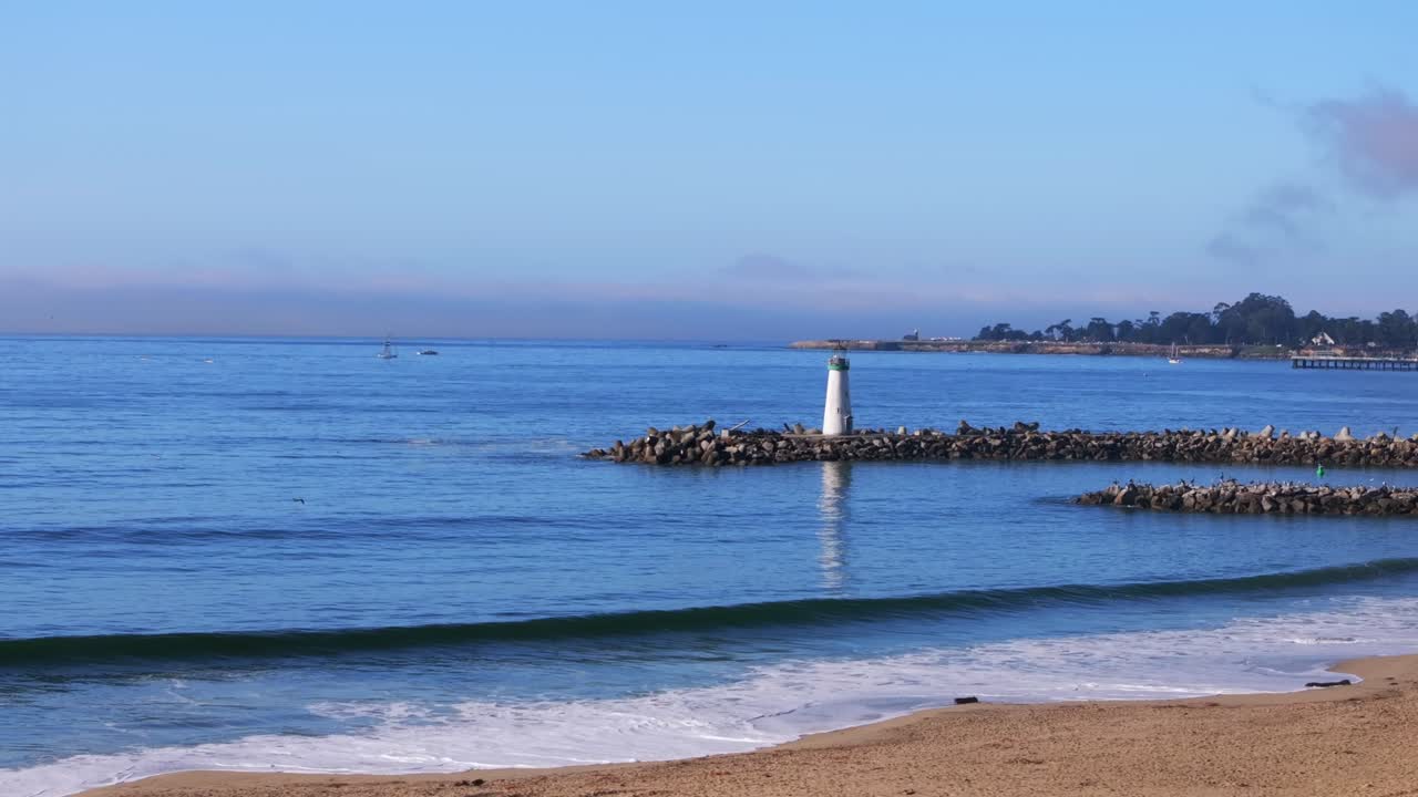 Blacks Beach Walton Lighthouse Jetty Santa Cruz California aerial drone sailboat scenic landscape deep blue surf waves tide sand Monterey Bay Pacific Ocean morning blue sky mist fog static motion