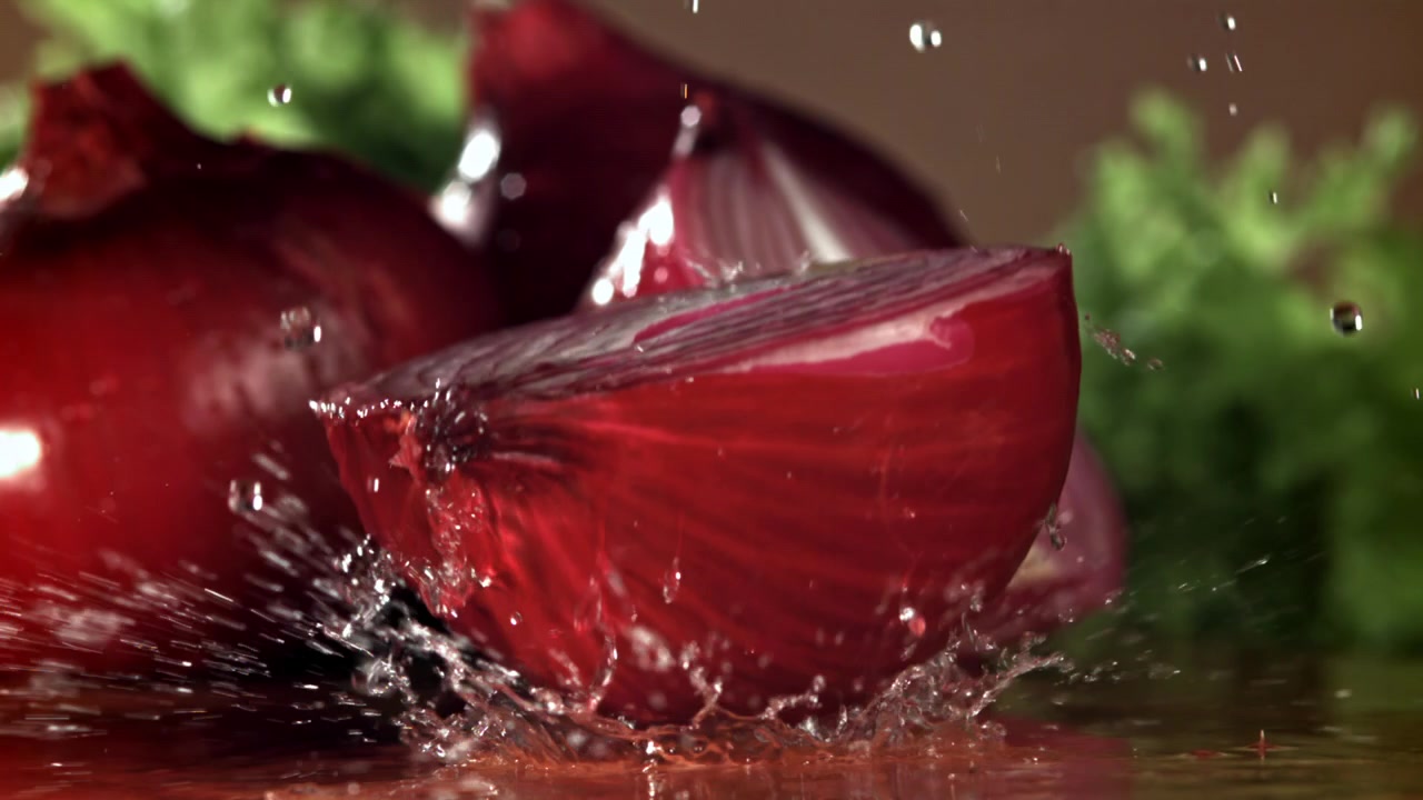 Fresh Red Onion Halves with Water Drops in Slow Motion