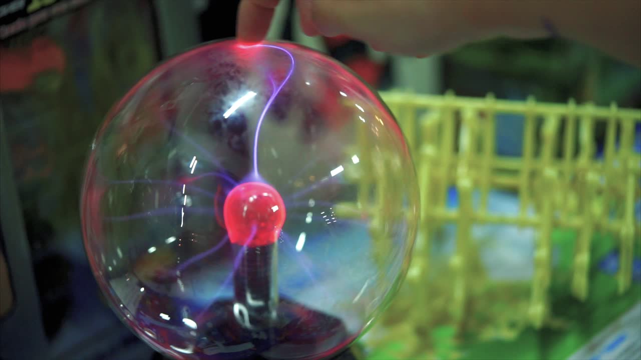 Child interacting with a Plasma Ball