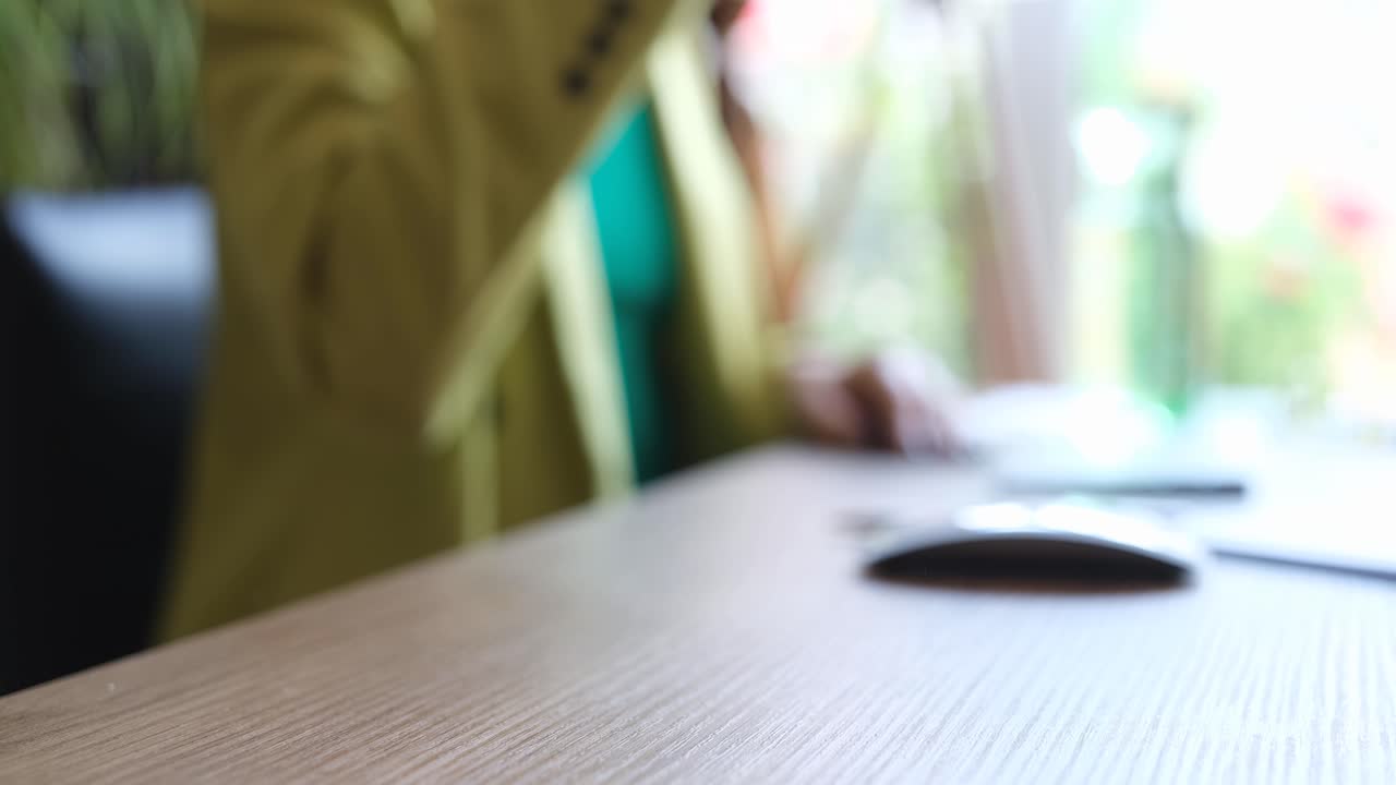 Water being poured into a glass on a desk