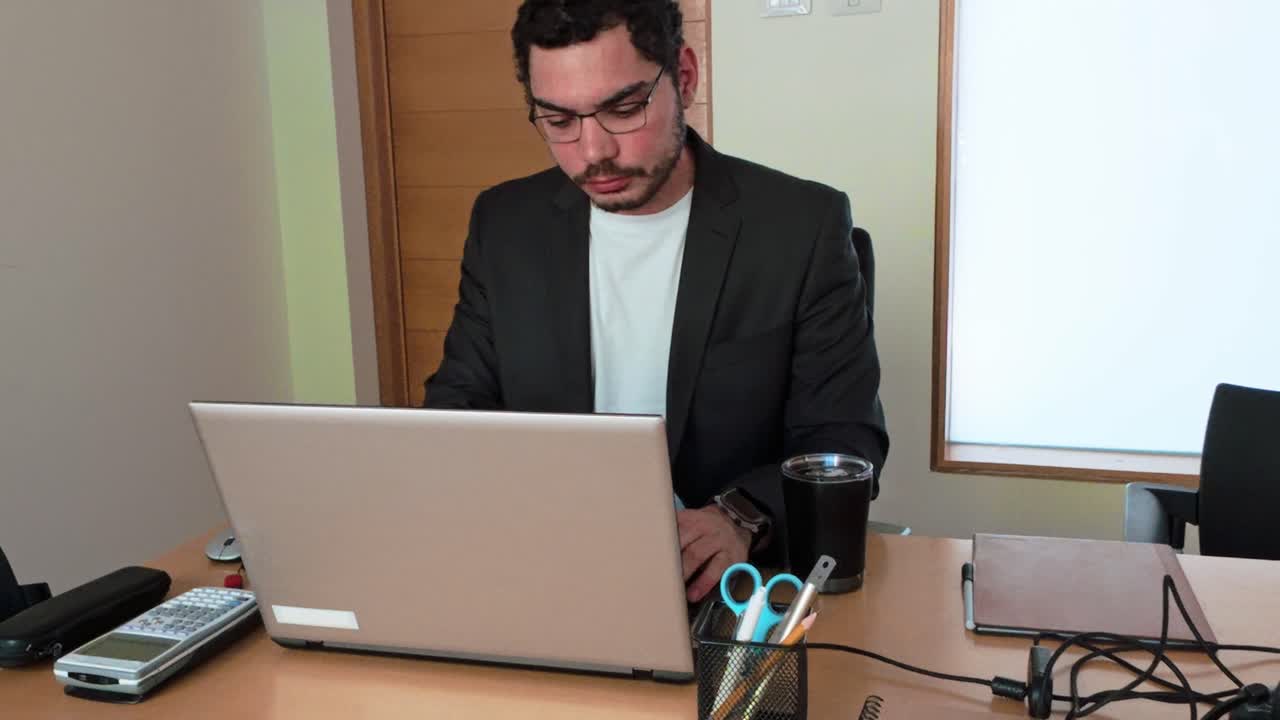 Stressed Young Businessman at Desk