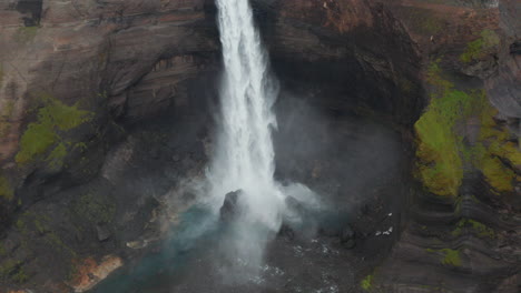 Aerial-view-of-Haifoss-waterfall-splashing-into-Fossa-river-in-Iceland-highlands.-Drone-view-of-one-of-most-important-powerful-icelandic-cascade-flowing-in-Landmannalaugar-canyon-valley