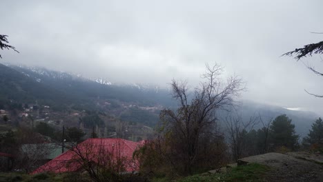 4k. view of winter mountain troodos in cyprus. pan from foot of the mountain with red tile roof