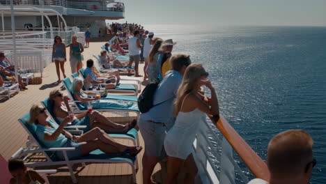 people relaxing on the deck of a cruise ship at sea
