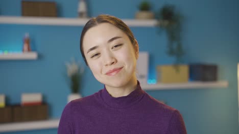 Asian-woman-looking-at-camera-smiling-at-camera-approaching-her.