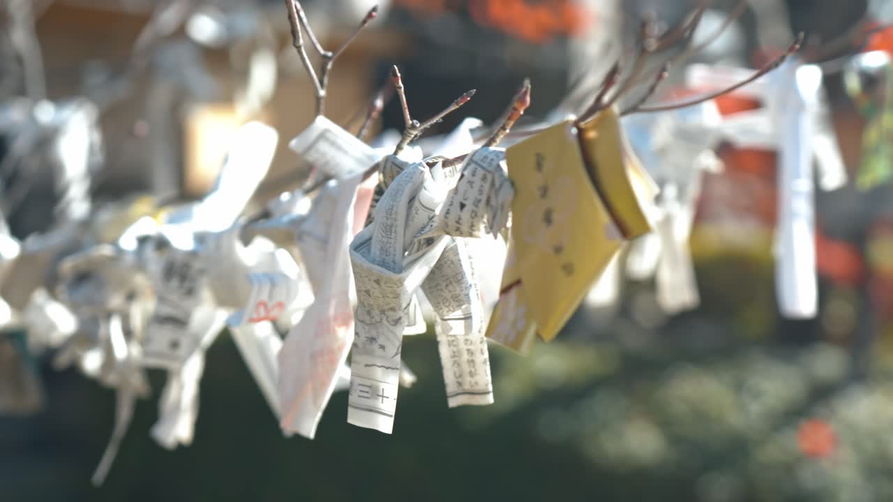 A close-up of an Omikuji, a traditional Japanese fortune-telling paper strip.