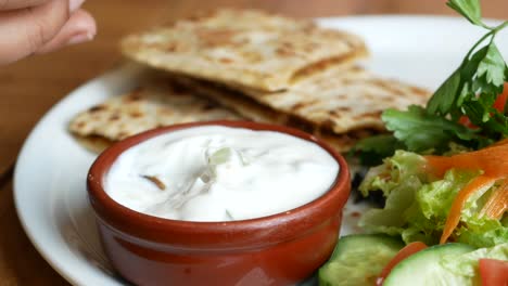 turkish pide with yogurt sauce and salad