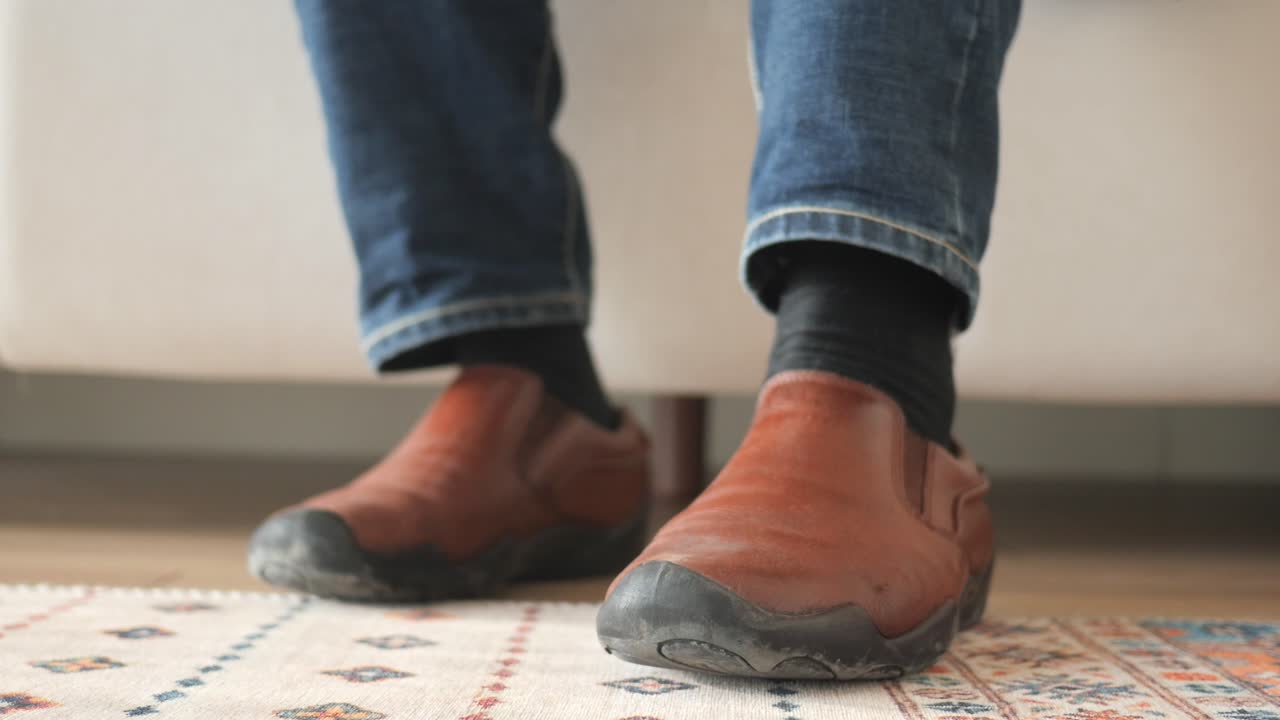 Person Sitting on Couch with Brown Shoes