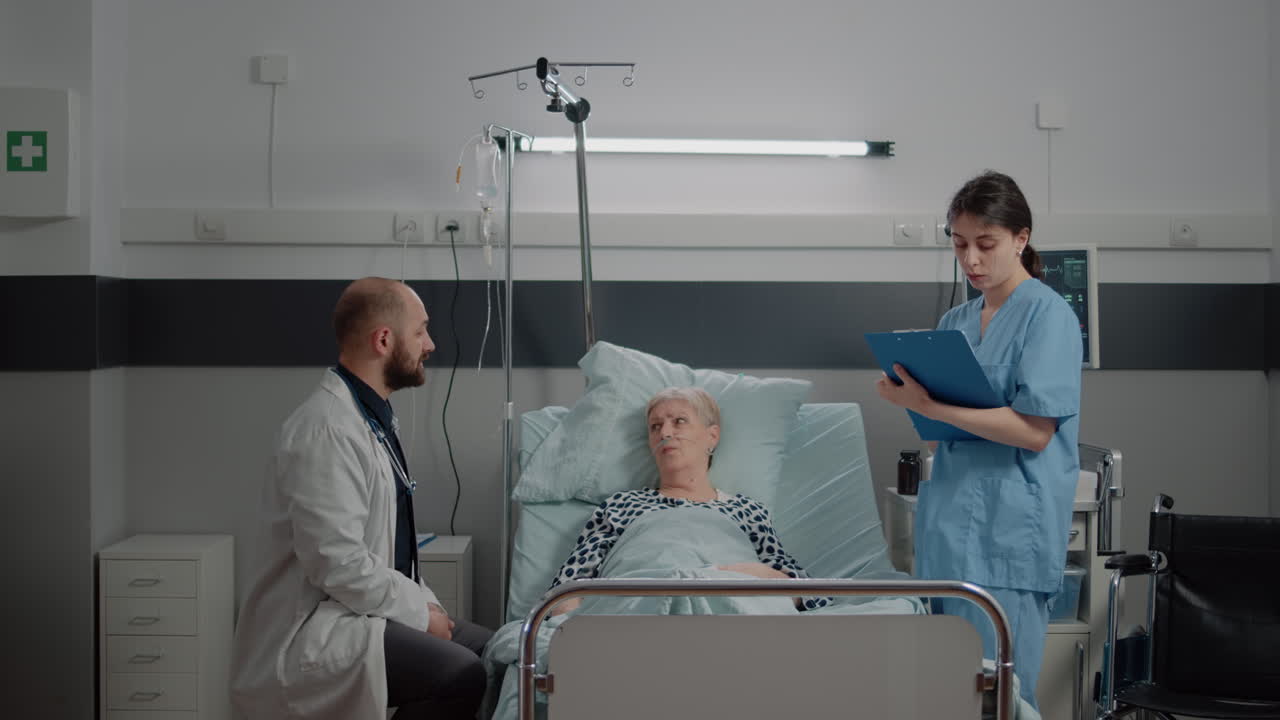 Medical team doing consultation with old patient in bed