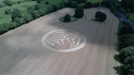 aerial view approaching mysterious warminster crop circle design with cloud shadow passing across rural farmland