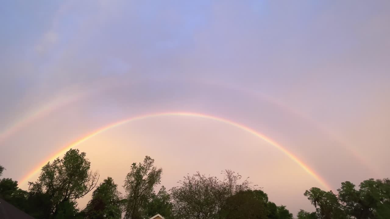Rare double rainbow fills sky over neighborhood after storm, 4k