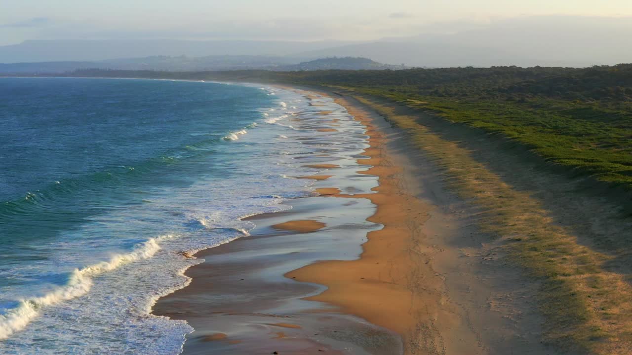Aerial view of Scenic Wild Natural Port Kembla Beach at Wollongong, NSW Australia - Tilt-up shot