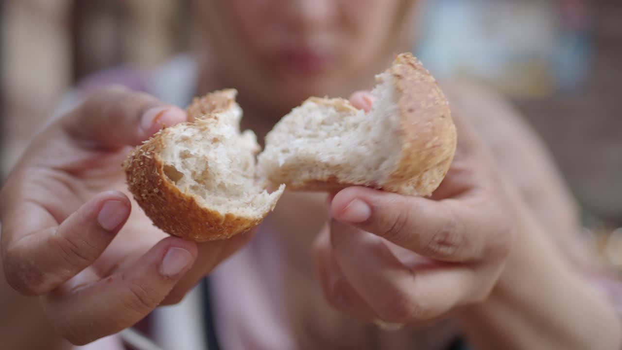 Person holding a piece of bread
