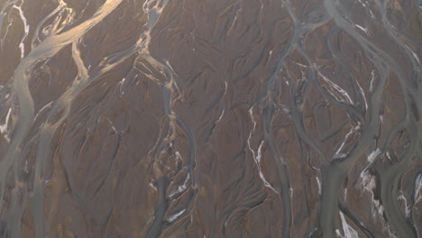 Top-down-aerial-shot-over-Icelands-braided-rivers