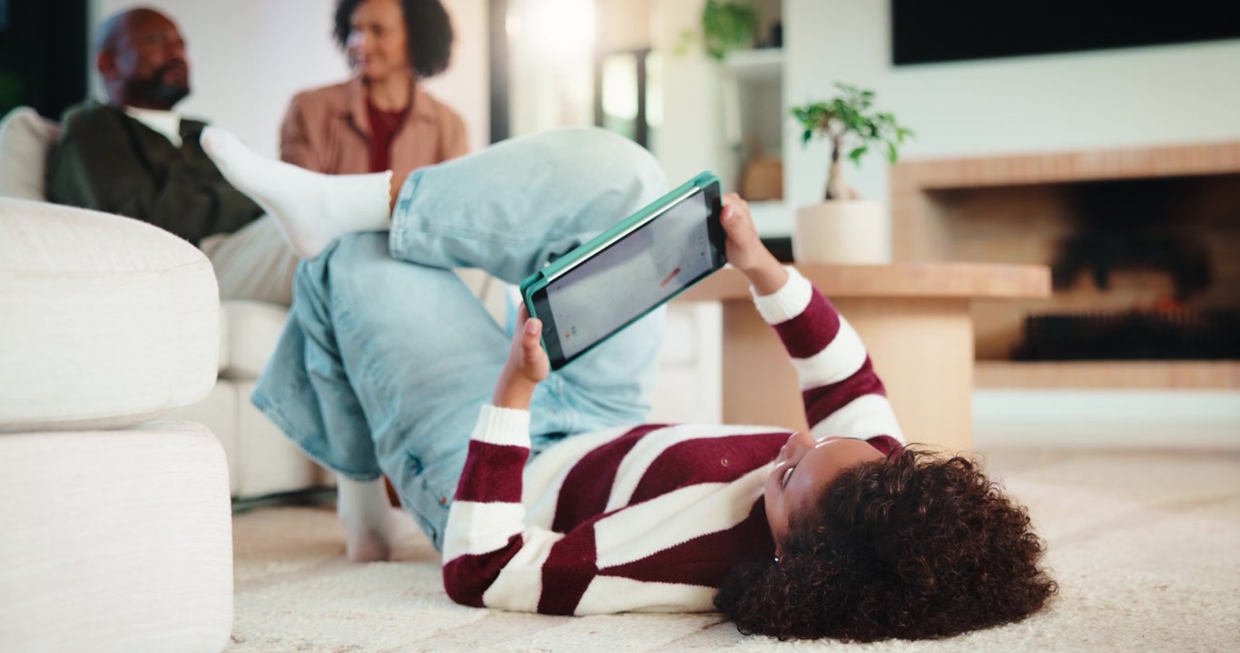Young Woman Relaxing on Living Room Floor Using Tablet