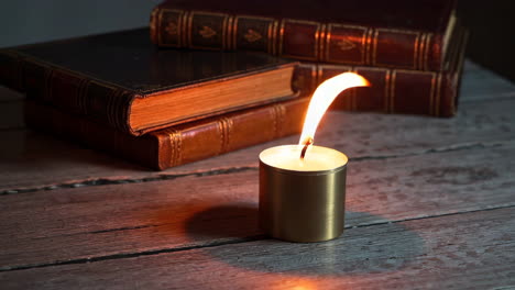 candle and antique books