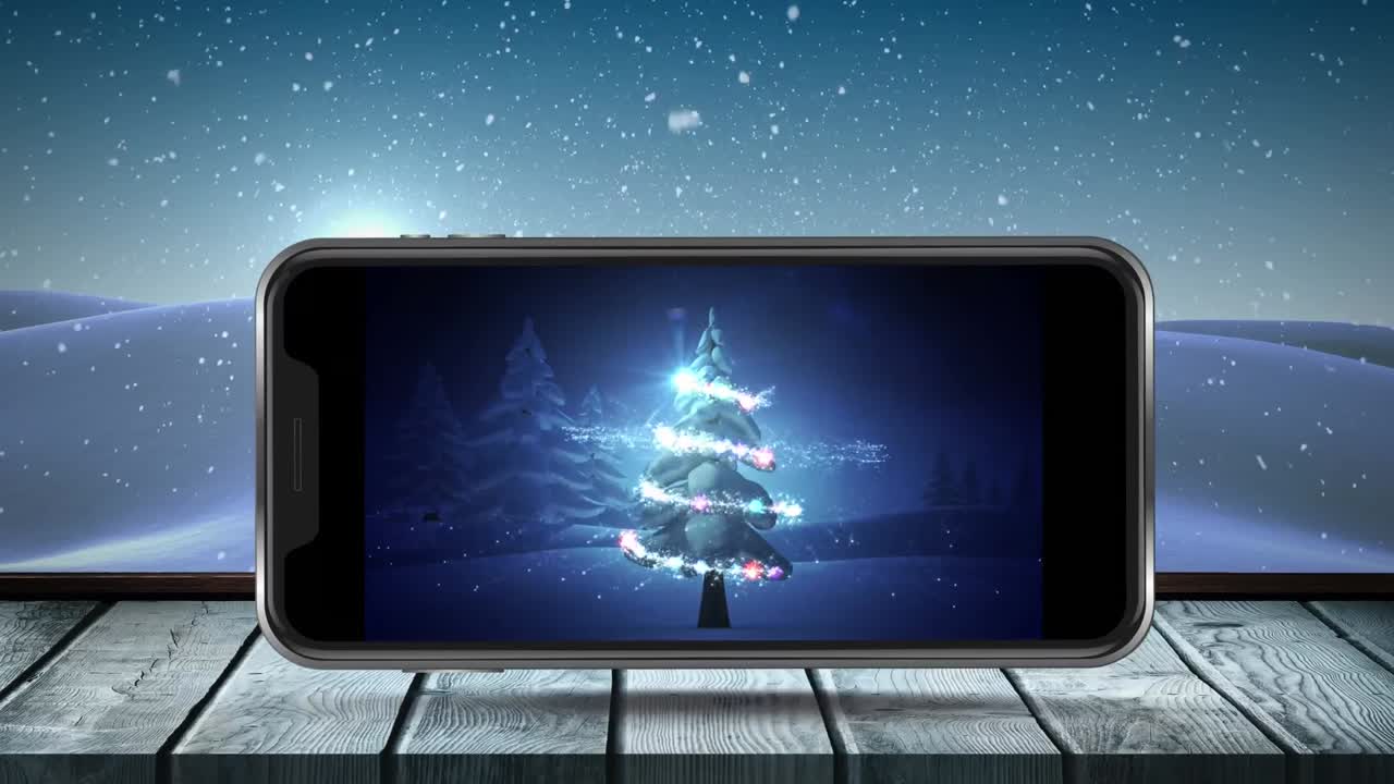 Animation of christmas tree on smartphone screen with winter scenery and snow falling
