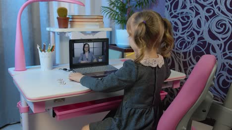 Preschool-child-girl-distance-online-education-at-home,-pupil-watching-video-lessons-on-laptop