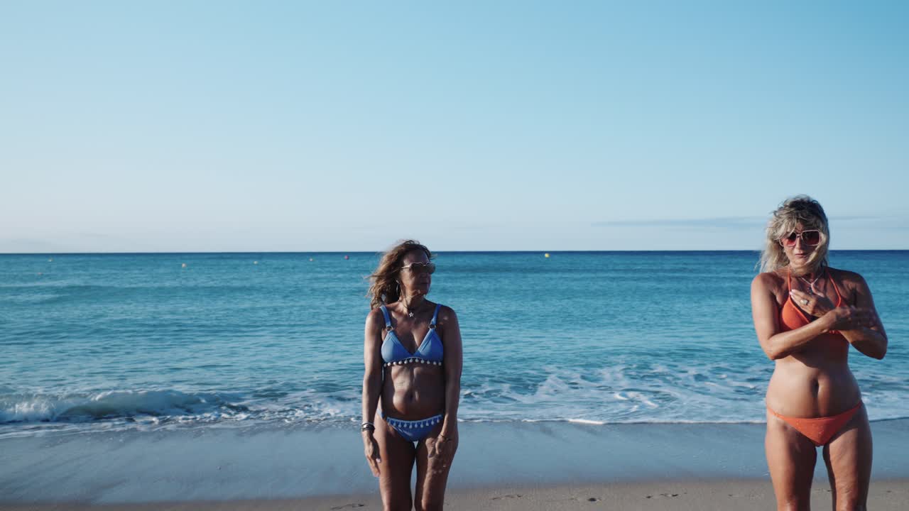 Women in Bikinis Exercising on the Beach