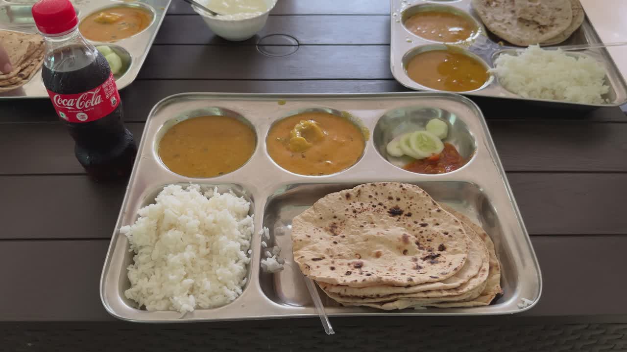 Indian Food in thali with coca cola
a Food platter complete Lunch lunch Meal. North Indian Thali