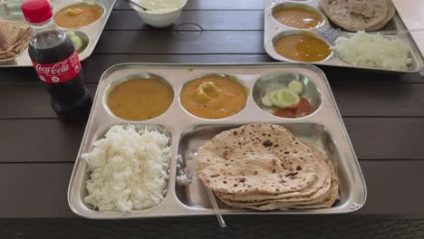 indian food in thali with coca cola
a food platter complete lunch lunch meal. north indian thali