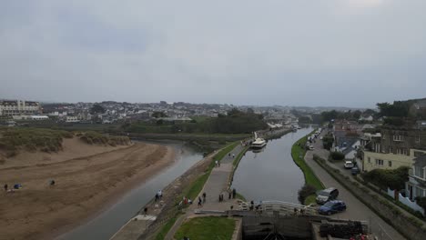 Bude-Canal-aerial-footage-reveal-over-Lock-gates-people-walking-along-path