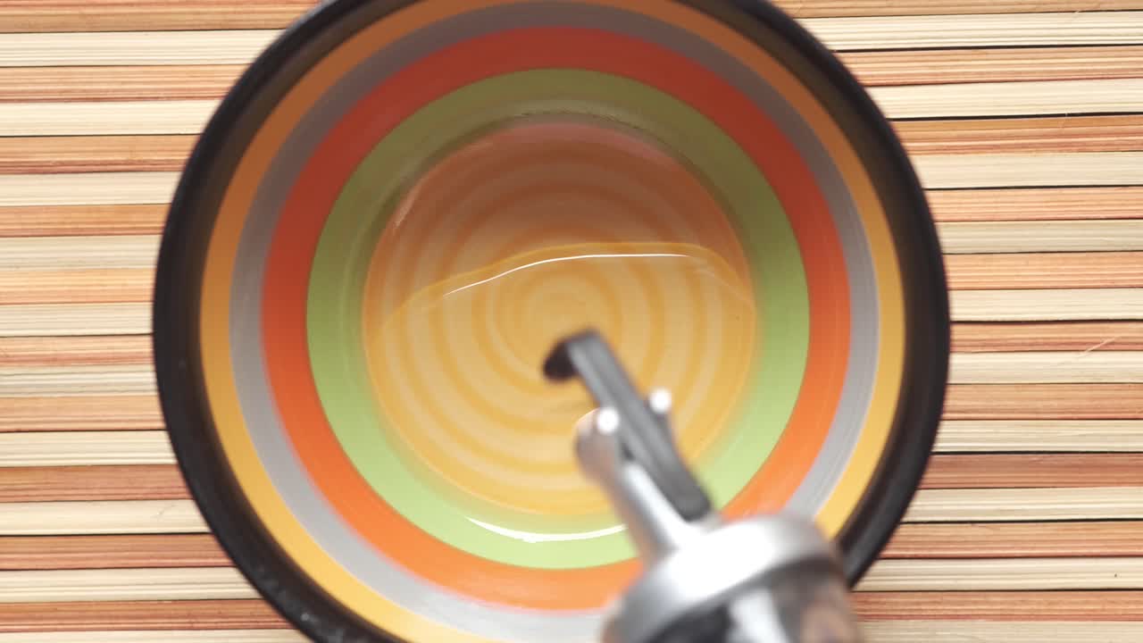 cuenco colorido con vertido de líquido