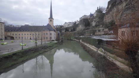 skyline of the grund in luxembourg city with neumunster abbey, alzette river, bock casemates and church of saint john