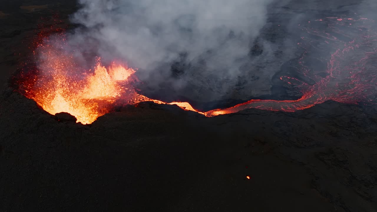 Aerial close up over the dramatic lava fountains within the eruptive crater of Sundhnukur