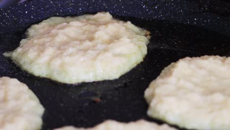 potato pancakes are fried in a pan, golden crust. delicious traditional food, macro.