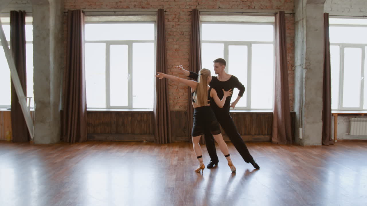 Couple Practicing Ballroom Dance in a Studio