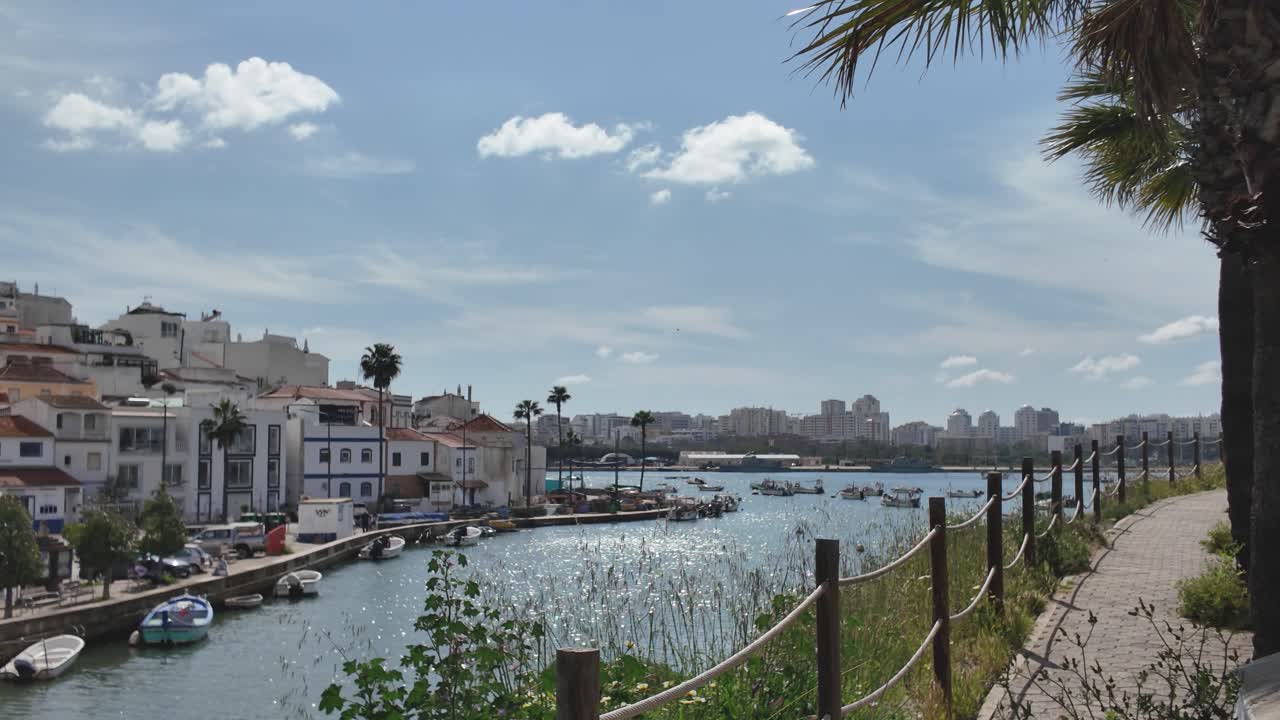 Beautiful view of Ferragudo, Portugal with boats by the waterfront and sunny skies