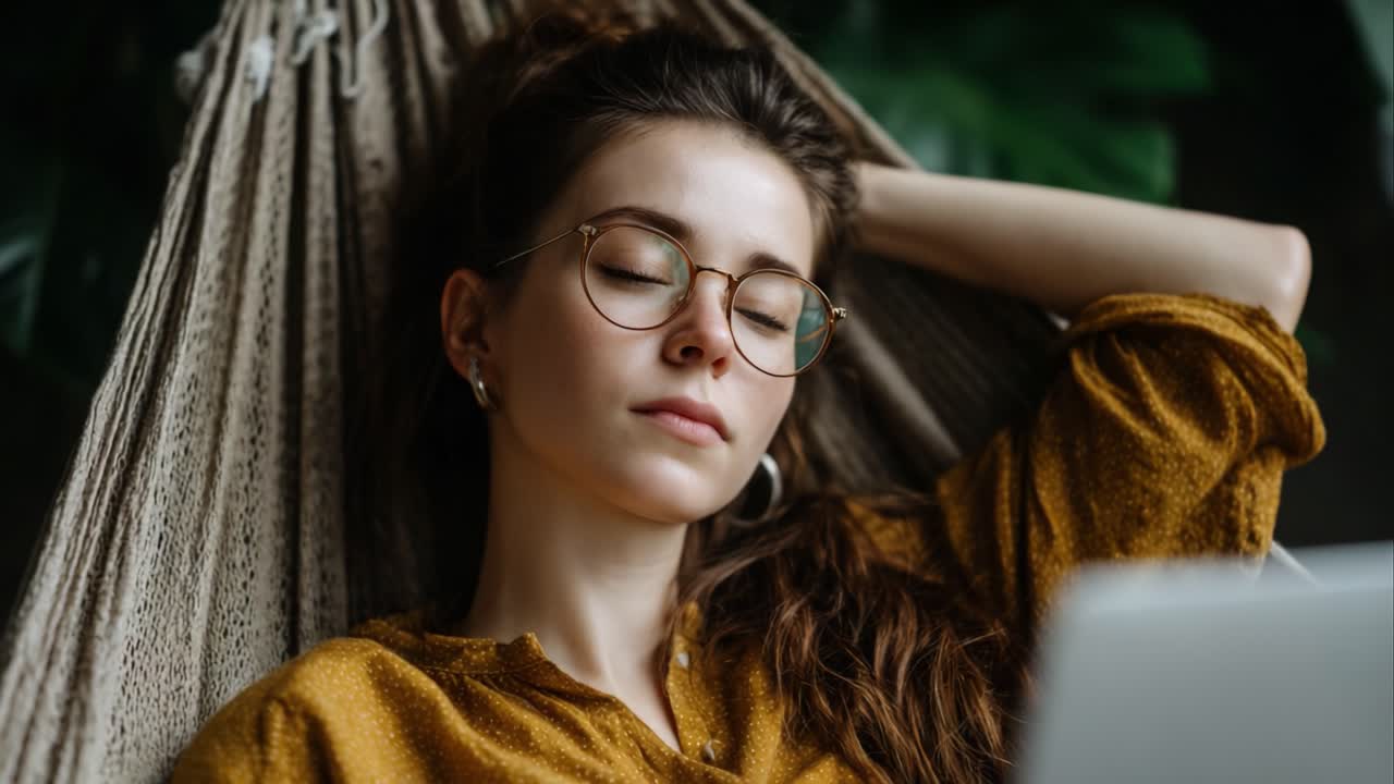 Relaxation and Contemplation: A Young Woman in a Hammock Enjoying a Moment of Peace and Serenity with Her Eyes Closed, Reflecting Among Nature