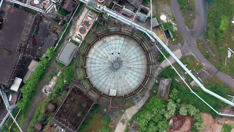 aerial top-down view of storage tank at abandoned steel factory