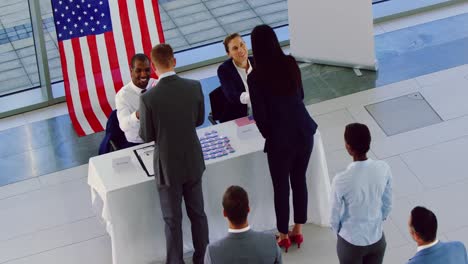 business people checking in at political campaign registration table 4k