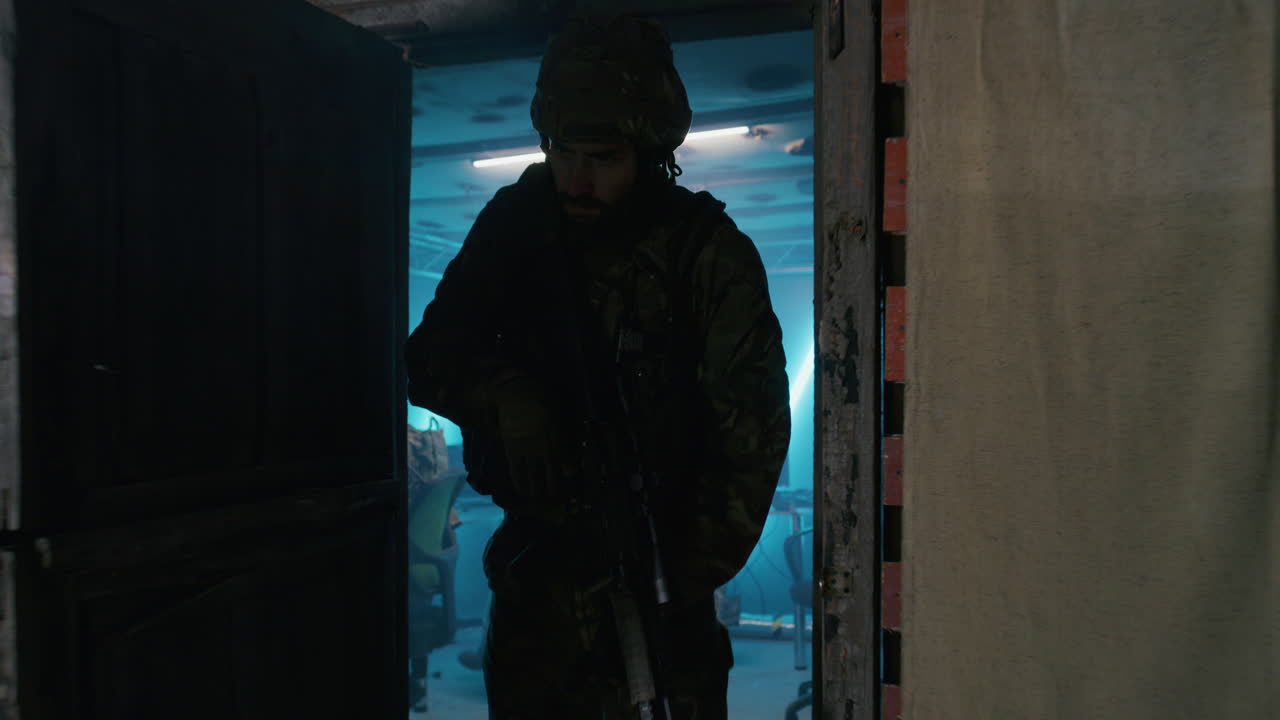 Soldier on patrol at night in a ruined building