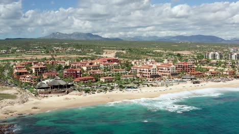 los cabos, baja california, mexico, aerial view of waterfront with turquoise ocean water and hotels and villas on beach