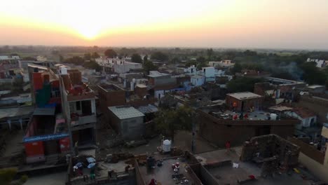 poverty and garbage in area of dooni city, rajasthan. aerial rising at sunset
