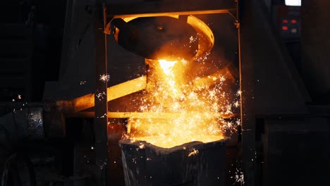 pouring bright hot liquid steel or metal from ladle in blast furnace foundry metallurgical factory