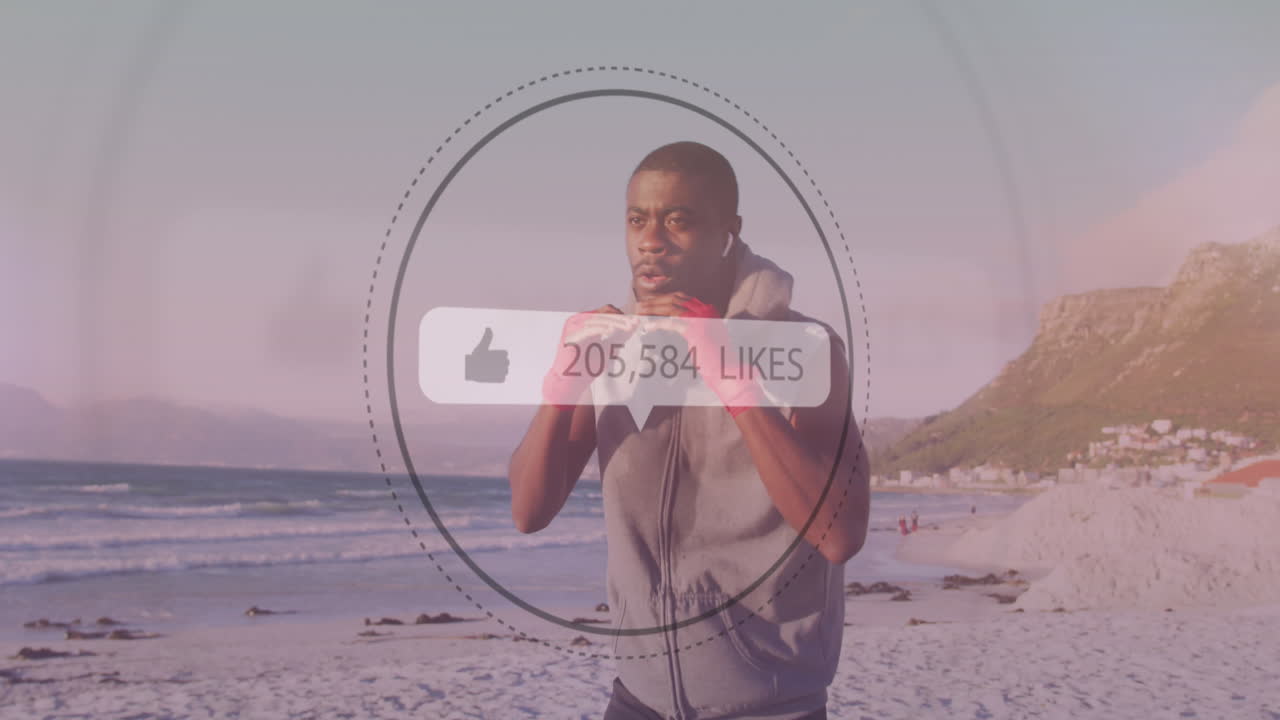 Speech bubble with increasing likes against african american male boxer practicing boxing at beach