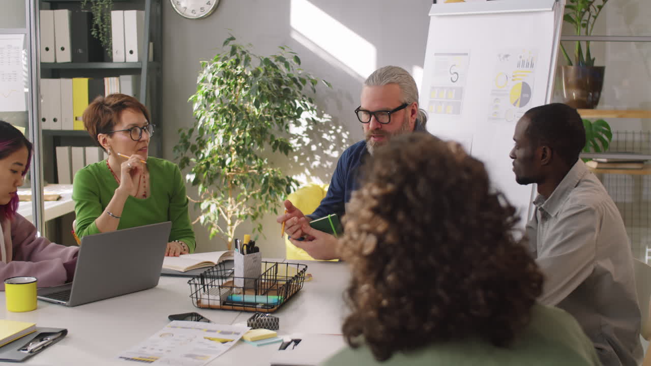 Senior Manager Speaking to Diverse Business Team at Meeting