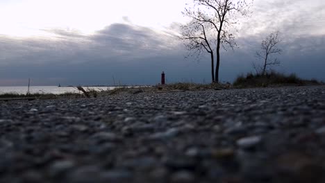 view of a lighthouse in muskegon from the rocky shoreline