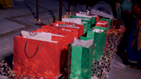 a table filled with colourful gift bags for guests