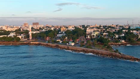 Obelisk-in-Juan-Baron-Plaza-and-amusement-park-along-Malecon-at-sunrise,-Santo-Domingo-in-Dominican-Republic