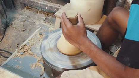 Close-Slow-Motion-Shot-of-a-Craftsman-Creating-a-Vase-on-a-Pottery-Wheel-in-the-Studio