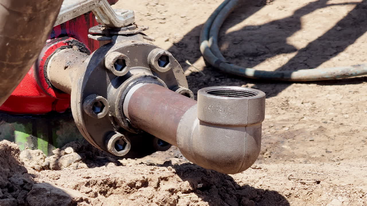 Gas goes up from the pipe bent up. Equipment at the site producing natural resources.