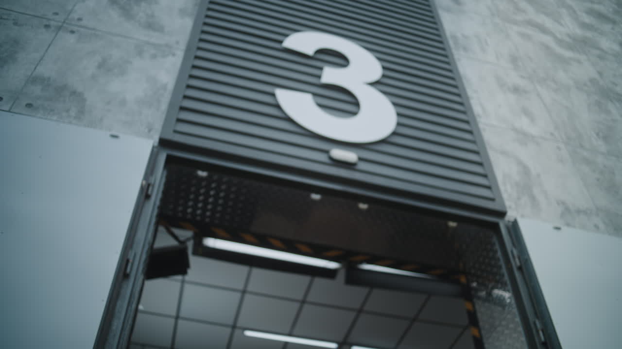 Delivery Workers Loading or Unloading a Package Outside a Building