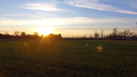 Fast-drone-flight-above-winter-field-at-sunset