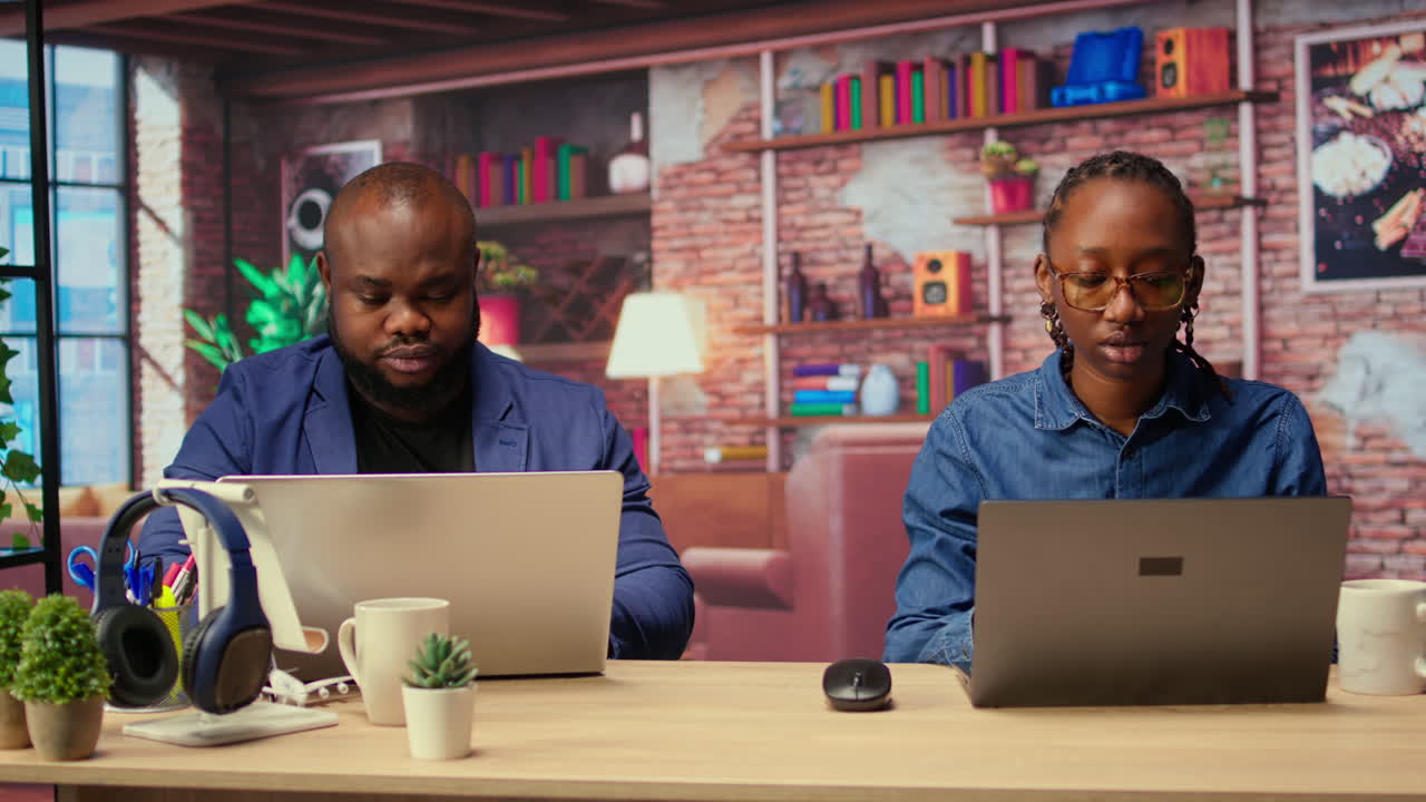 African American couple at their home office collaborate on a project