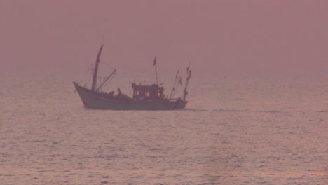 fishing boat in sea at sunset